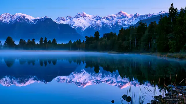 Morning light over a mountain lake with reflections