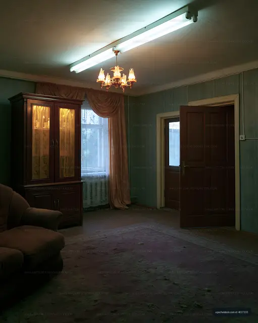 Empty room with a sofa and a chandelier