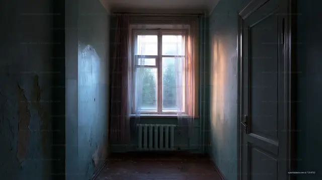 Empty room with peeling walls and window light in old building
