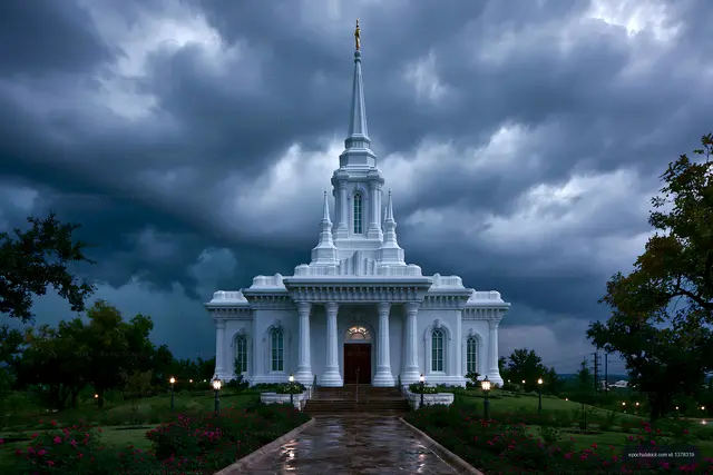 White church building under dark stormy sky