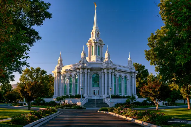 White temple building with tall spire in clear blue sky