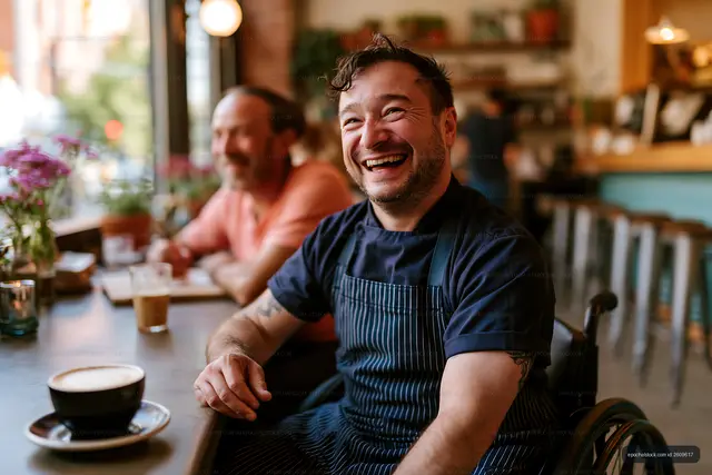 Chef in wheelchair enjoying coffee in a cafe with friends