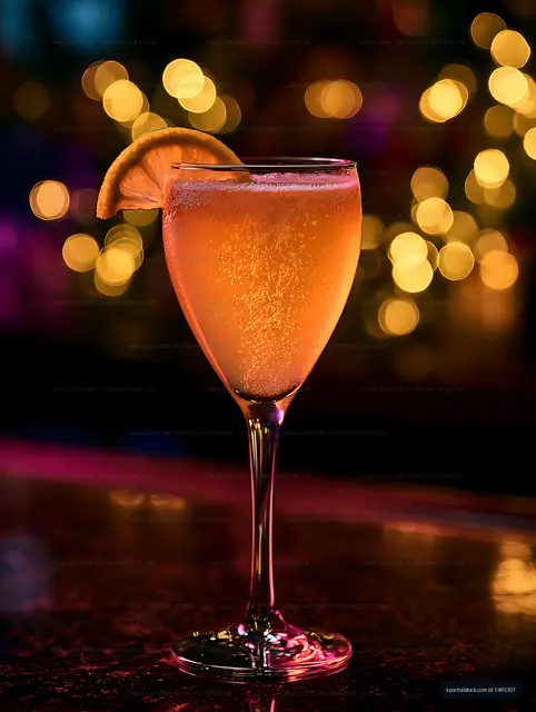 Bubbly amber citrus drink with orange garnish