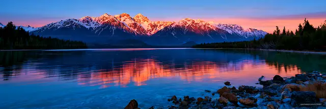 Colorful alpine sunset over a reflective mountain lake