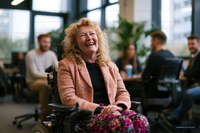Happy woman laughing while seated in a wheelchair