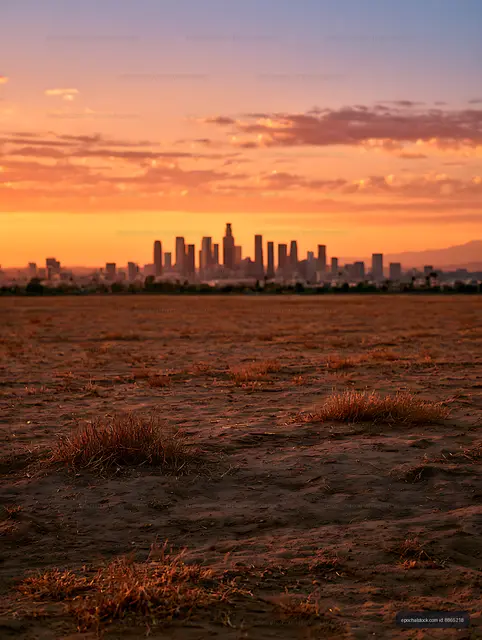 Silhouetted skyline across a dry landscape at sunset