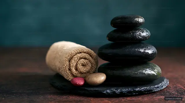Stacked stones with towel and colorful pebbles