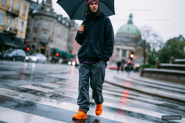 Rainy urban walk with umbrella and reflected city lights