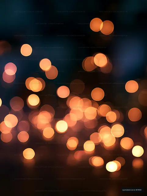 Soft orange bokeh circles in a dark abstract composition