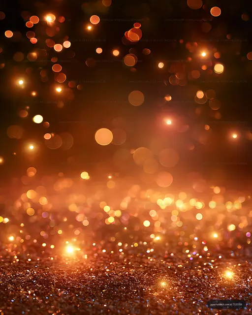 Orange and gold bokeh lights above a glittering surface