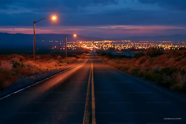 Evening Road Illuminated by Streetlights and City Glow