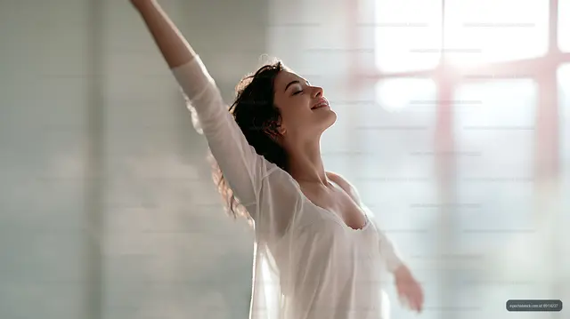 Woman enjoying sunlight while dancing indoors