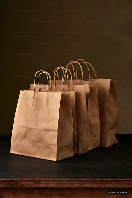 Plain brown paper bags arranged on a wooden tabletop