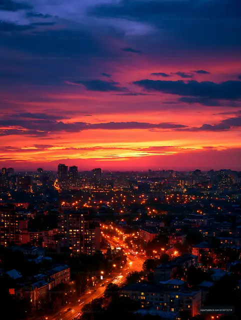 Dramatic dusk skyline with glowing city streets