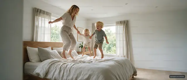 Mother and children playing on a bed