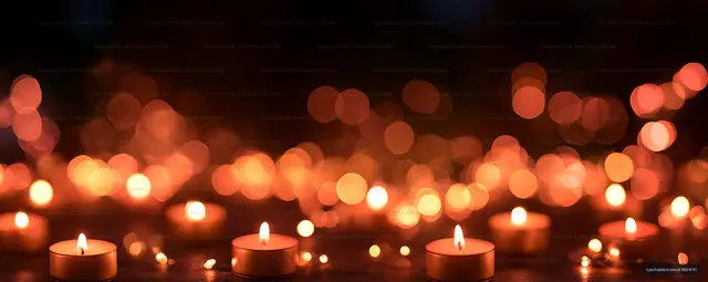 Tealight candles glowing against a dark bokeh background