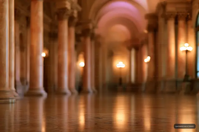 Soft focus interior with columns, arches, and warm lights