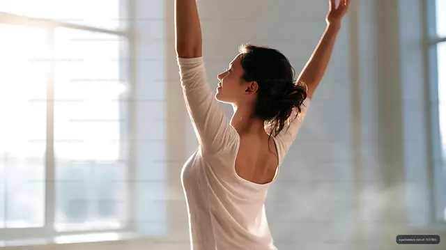 Side view of woman stretching near large windows