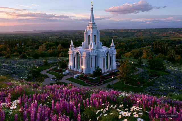 Ornate white temple and flower gardens at dusk