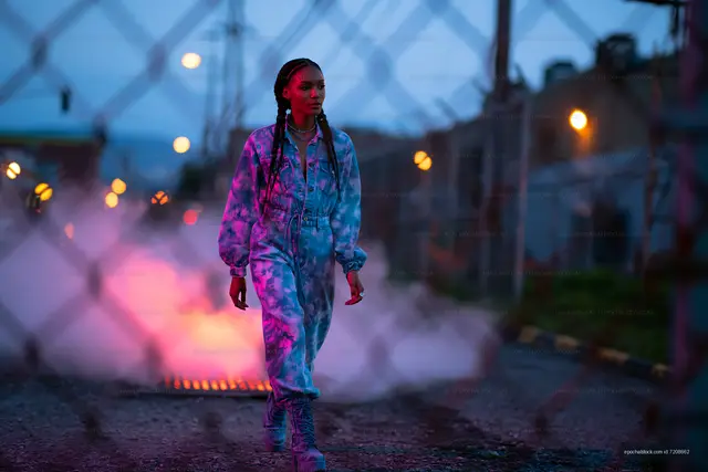 Woman in patterned jumpsuit on a foggy path
