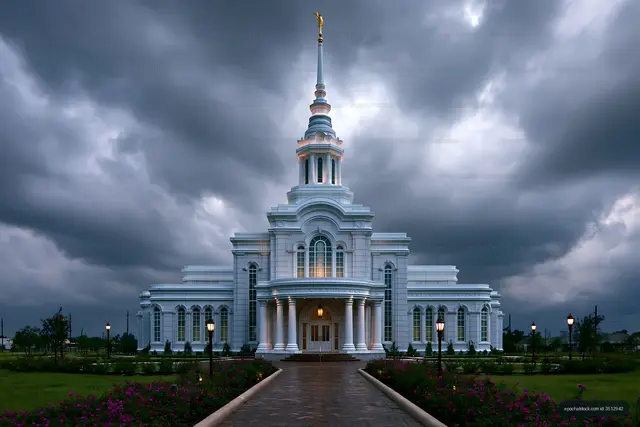 Illuminated white temple beneath a dramatic cloudy sky