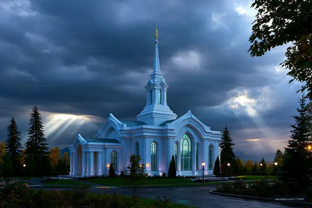 White steepled church under dramatic clouds and sunbeams