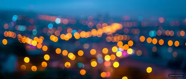 City skyline with bokeh lights at night during twilight